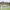 Golfer takes a shot in front of club house, Africa Amateur Championship
